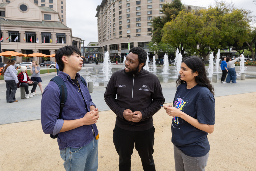 Students gathering, speaking with each other and posing for photographs.