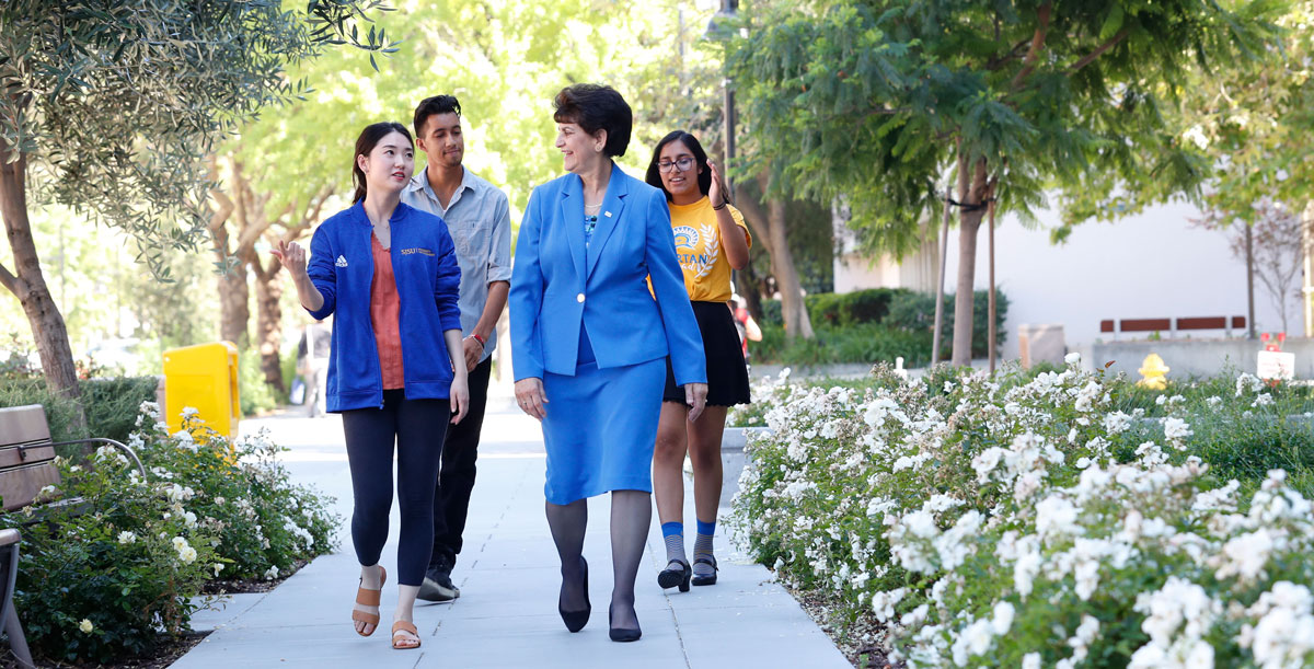 Mary A. Papazian walking with students.