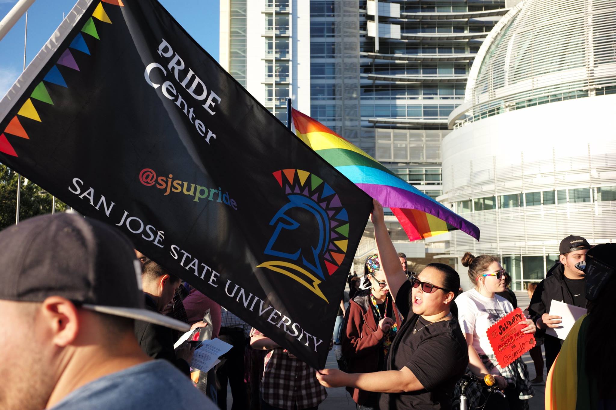 A black flag with a rainbow colored SJSU Spartan and the words PRIDE center.