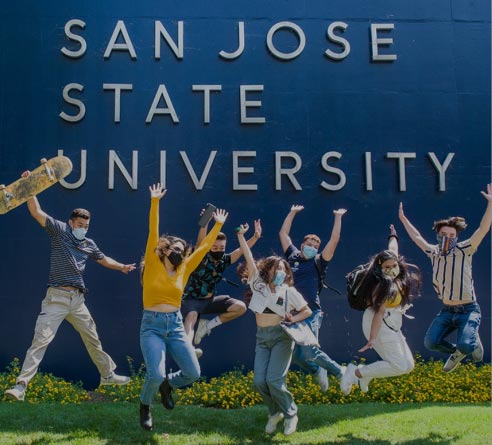 Students in front of the San Jose University sign