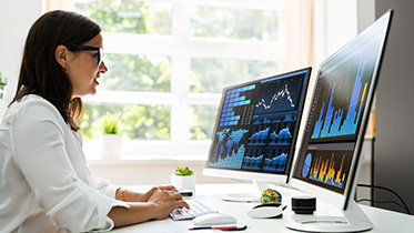 Woman staring at data on a computer