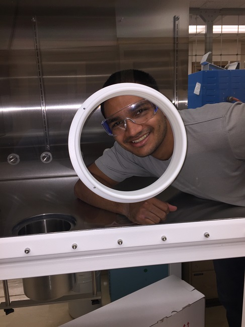researcher David poses from inside the glovebox