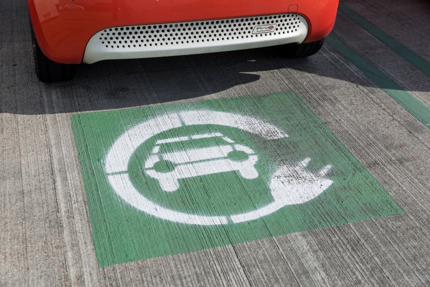 Electric car sign painted on parking space.