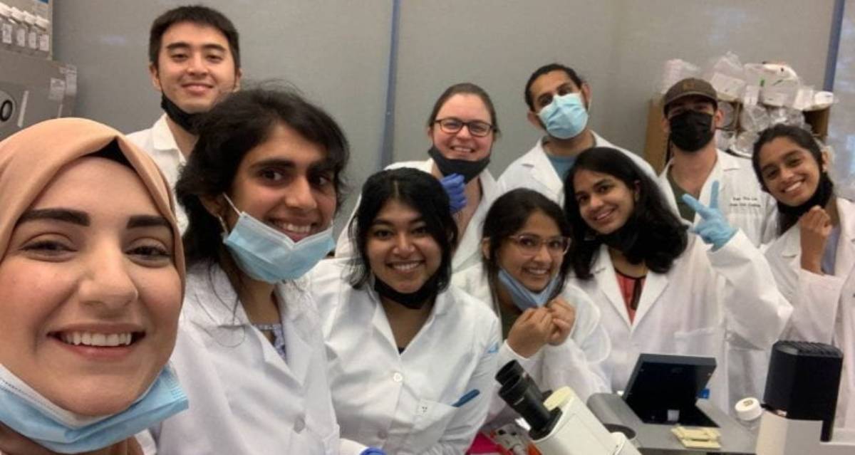 Group picture showing the team in a lab