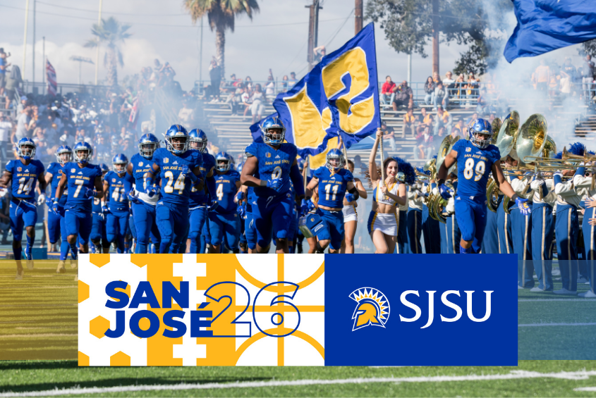 Football team running down the football field at CEFCU Stadium.