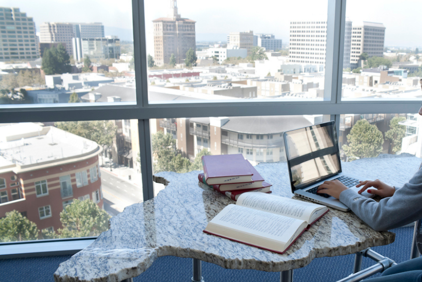 interior of MLK Library reading table with a newspaper open on the table