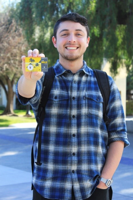 Student holding VIP Gold Card