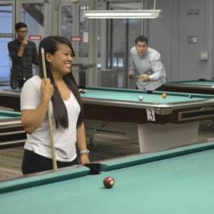 Picture of student playing billiards.