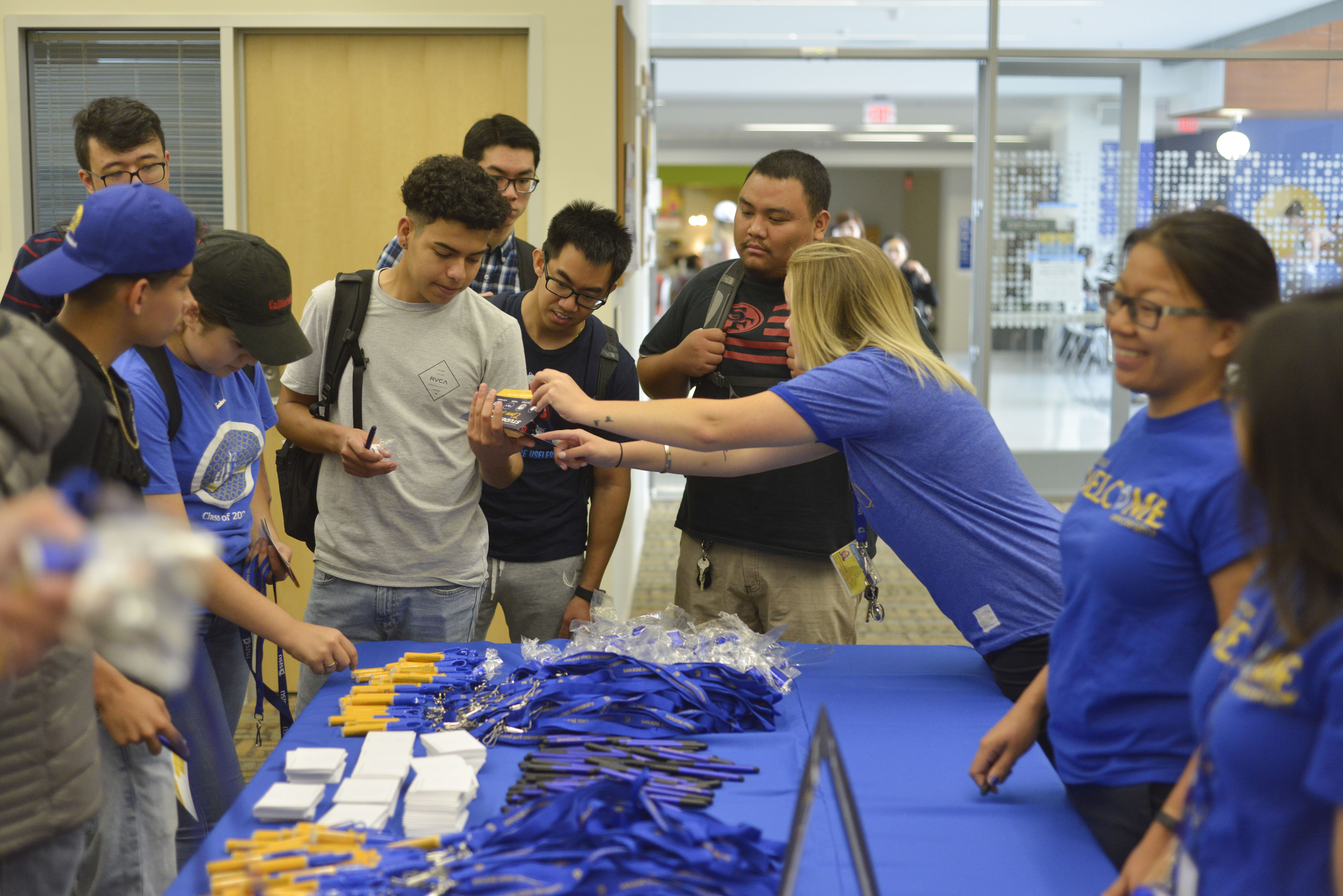 staff members from the student union handing out merchendise 