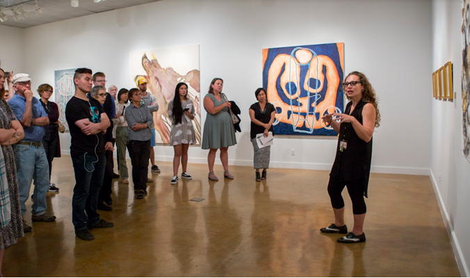 Instructor Irene Carvajal at the Pictorial Arts Faculty Exhibition walk-through in 2017.