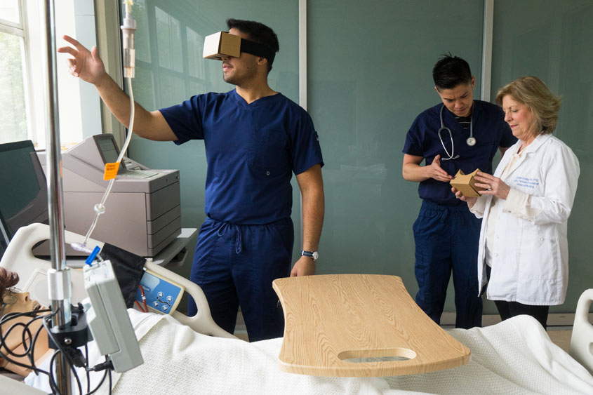 A nursing student practices with a VR headset.