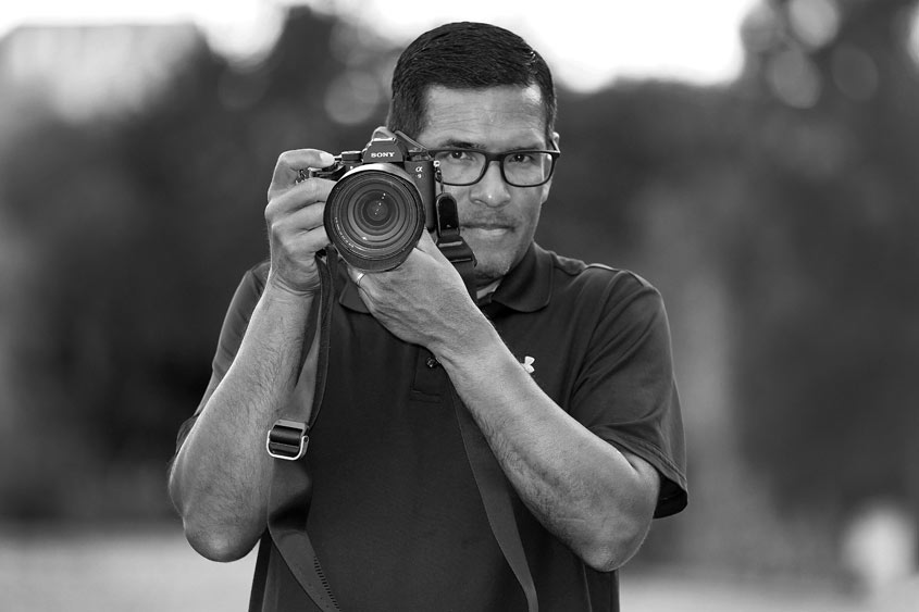 Marcio Sanchez holding a camera.